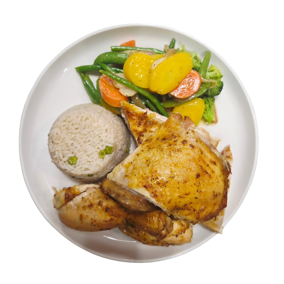Grilled chicken pieces, rice with peas, and mixed vegetables including green beans, carrots, and yellow squash.